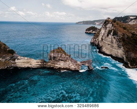 Dramatic Drone Shot Of Beautiful Cliffs In Indonesia With Blue Ocean.