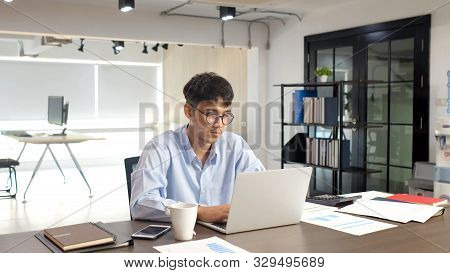 Young Asian Businessman Concentrate On Working With Laptop Computer At Office, Asian Office Man Comt