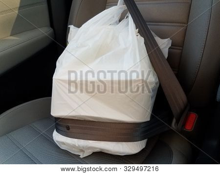Plastic Bag With Take Out Or Delivery Or To Go Food In Seatbelt In Car