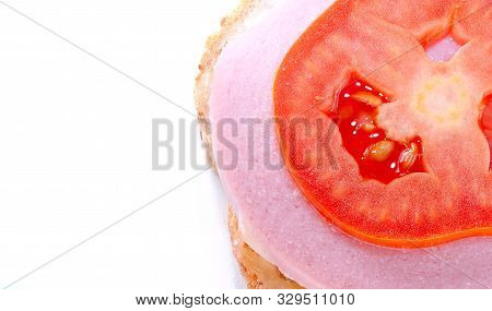 Details Of An Open Sandwich Of One Slice Of Bread, Cheese, Cooked Sausage And Tomato On Top. Copy Sp