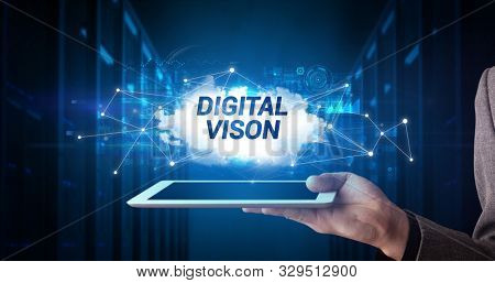 Young business person working on tablet and shows the inscription: DIGITAL VISON