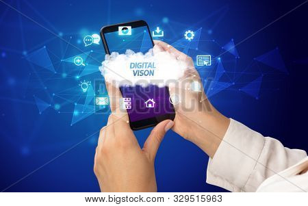 Female hand holding smartphone with DIGITAL VISON inscription, cloud technology concept