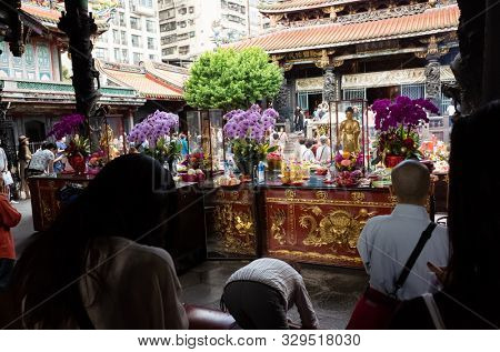 Taipei, Taiwan - October 20th, 2019: people praying in Lungshan temple at Taipei, Taiwan