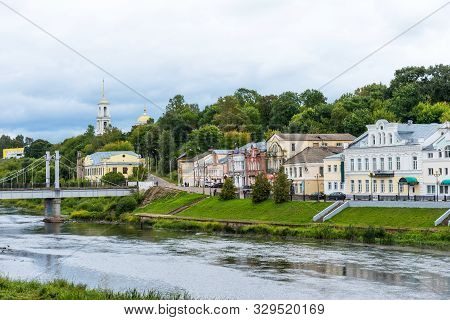 Torzhok, Russia - August 4, 2019: Panoramic Summer View Of The Embankment Of The Tvertsa River With 
