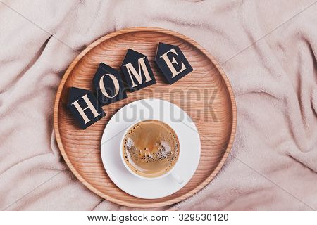 Coffee And Wooden Letters Arannged Into Word Home Lying On The Wooden Tray