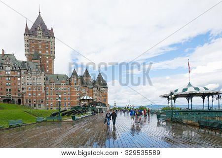 Quebec City, Canada - August 6, 2015:people Stroll On The Dufferin Terrace With The Famouse Frontena