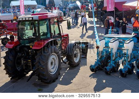 Chisinau, Moldova, October 22, 2019. Agricultural Machinery With Visitors At The Exhibition