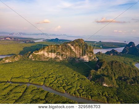 Aerial Top View Of Samet Nangshe And Tropical Green Forest Trees At Sunset With Andaman Sea In Phang