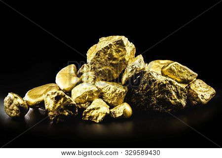 Nugget Of Raw Gold, The Most Expensive Gemstone In The World. Mining And Mineral Extraction Concept.