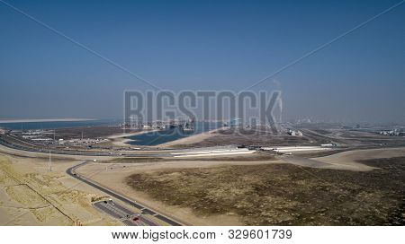 Large Harbor Cranes Loading Container Ships In The Port Of Rotterdam