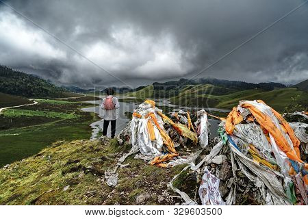 Alpine Lakes And Hikers In Muli Tibetan Area, Sichuan Province, China.