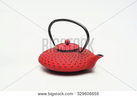 Red Cast Iron Teapot On A White Background.