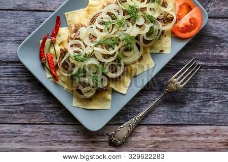 Beshbarmak Is A National Kazakh Dish - Square Pasta With Boiled Meat And Onions.