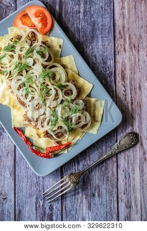 Beshbarmak Is A National Kazakh Dish - Square Pasta With Boiled Meat And Onions.