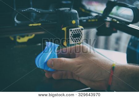 Modern 3d printer with printed three dimentional model of vase. 