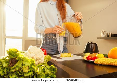 Beautiful Redhaired Ginger Woman Making Fruits Smoothies With Blender, Preparing Drink With Bananas,