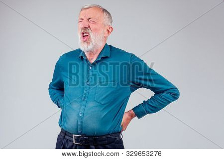 Sick Senior Old Man Suffering Face Expression, Spine Ache Pain In Studio White Background