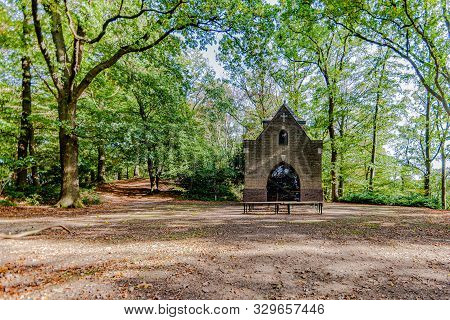 Chapel Of Mary Or Chapel Of Peace In The Middle Of The Forest With Wooden Benches Outside Surrounded