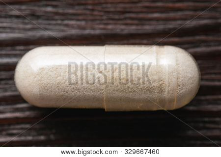 White Medical Capsules Of Glucosamine Chondroitin, Healthy Supplement Pills On Wooden Background, Ma