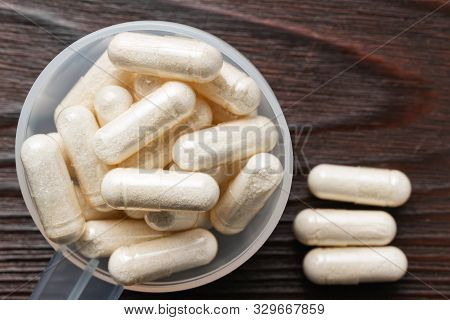 White Medical Capsules Of Glucosamine Chondroitin, Healthy Supplement Pills In The Plastic Spoon On 
