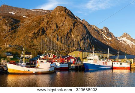 Ramberg village, Lofoten Islands, Norway, Fishing boats in harbor at midnight sun, Mountain With Snow In Background