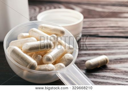 White Medical Capsules Of Glucosamine Chondroitin, Healthy Supplement Pills In The Plastic Spoon On 