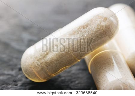 White Medical Capsules Of Glucosamine Chondroitin, Healthy Supplement Pills On Dark Background, Macr