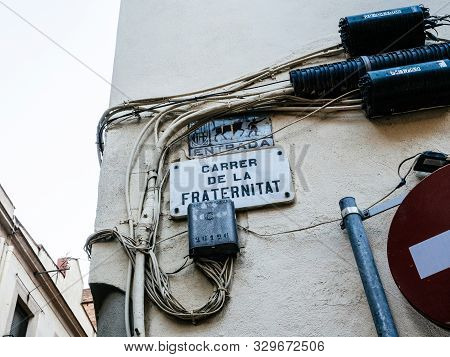 Barcelona, Spain - Nov 16 2017: Low Angle View Of Carrer De La Fraternitat Street Name Translated As