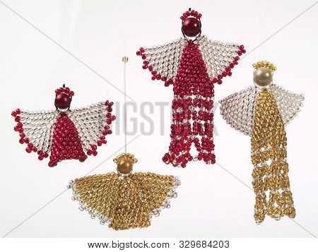 A Picture Of Four Beaded Red, White And Gold Wired Angels Christmas Tree Decorations With Pearls As 