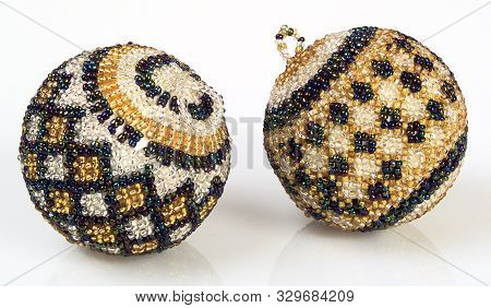 A Pic Of Two Blue White And Gold Beaded Balls Christmas Tree Decorations
