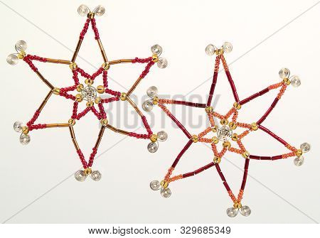 A Picture Of Two Colourful Beaded Wire Stars Christmas Tree Decorations With Twirly Ends