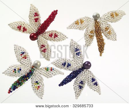 A Pic Of Four Colourful Beaded Dragon Flies Christmas Tree Decorations