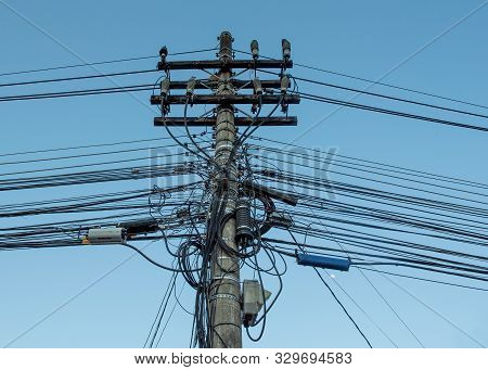A Mess Of Entangled Electricity Wires And Pole, On A Street In Brazil