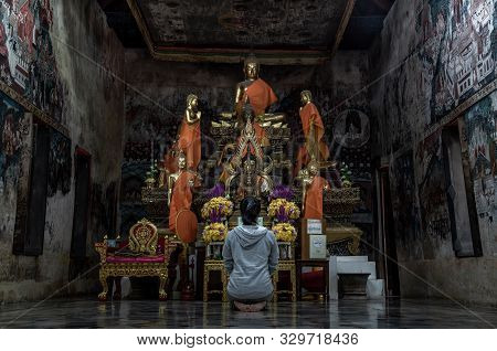 Ratchaburi, Thailand - Sep 22,2019 : Young Woman Sitting Praying Pay Respect To Buddha Statue In The