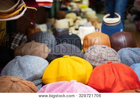 Set Of Newsboy Cap On Stall In Market