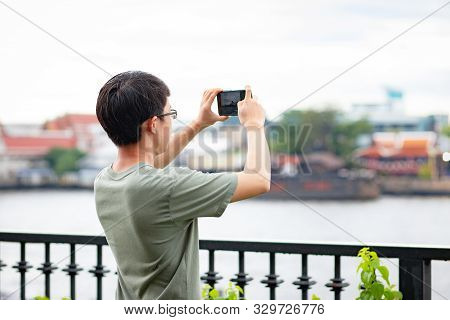Man Calling Phone On The Riverside View Point