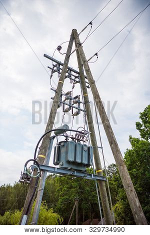 Transformers And High Voltage Cables On The Pole. Three-phase Transformers For High Voltage Transfor