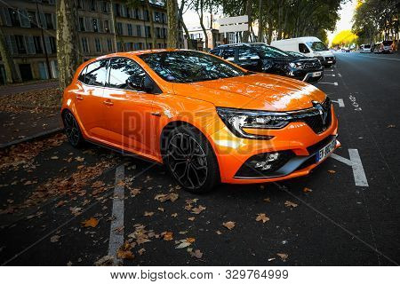 Versailles, France - September 15, 2019: Orange Hatchback Renault Clio In The City Street.