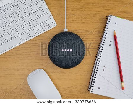 Smart Home Device Speaker At Full Volume On Wooden Table Desk