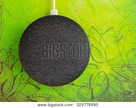 Smart Home Device Speaker On Lime Green Bright Floral Background