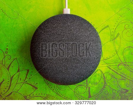 Smart Home Device Speaker On Green Bright Colour Pattern Background