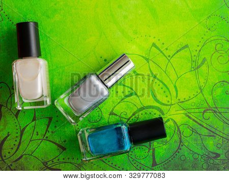 Nail Paint Varnish Bottle On Green Floral Background
