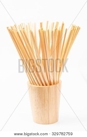 Wheat Straw For Drinking Water In Wooden Glass On White Background. Zero Waste Concept.