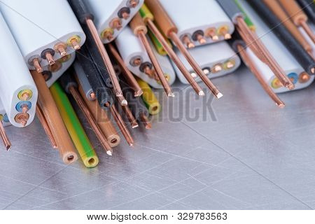 Copper Cable And Wire Used In Electrical Installation On Metal Workshop Table