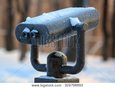 Binoculars In The Park In Winter At Dawn.