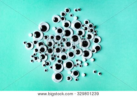 Bunch Of Plactic Wiggly Eyes On Green Background