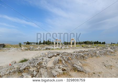 Elements Of Antique Ruins Of Limestone Blocks. The Destroyed Columns. Ruins Of The City Of Hierapoli