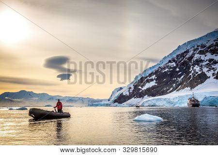 Zodiac Boat And Passanger Cruise Liner  In The Snow Fjord With Glacier And Icebergs, Neco Bay, Antar