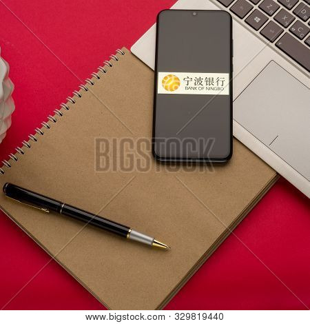 Tula, Russia - October 19, 2019: Logo Bank Of Ningbo Displayed On A Smartphone Near Modern Laptop On