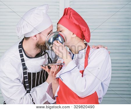 Tasty Kiss. Family Cooking In Kitchen. Secret Ingredient By Recipe. Cook Uniform. Man And Woman Chef